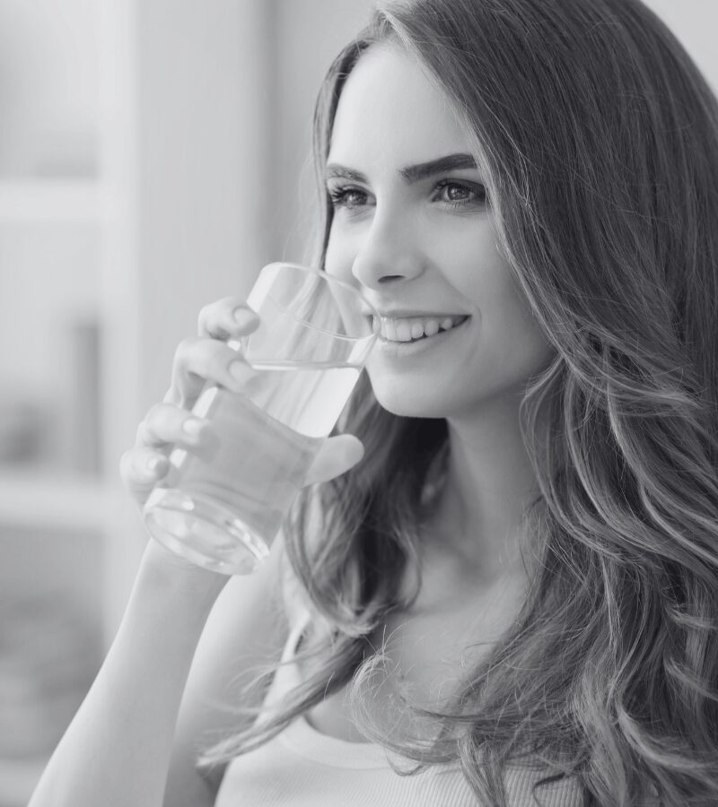 Woman rinsing mouth with warm salt water